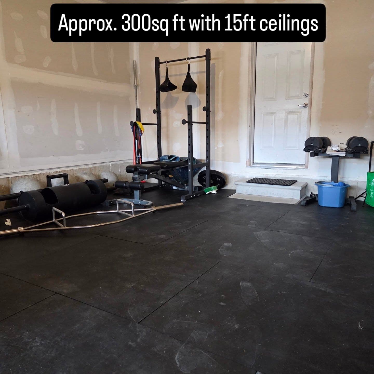 Trap bar, bench, and plate loaded equipment inside SWALL Fitness